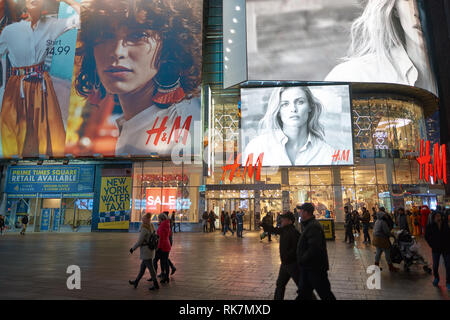 NEW YORK - CIRCA MARCH 2016: Times Square H&M store at night. H & M Hennes & Mauritz AB is a Swedish multinational retail-clothing company, known for  Stock Photo