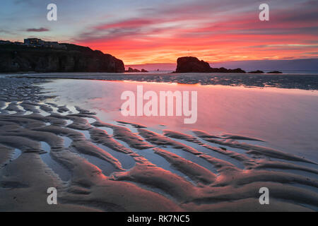 Chapel Rock on Perranporth Beach in Cornwall captured at sunset. Stock Photo