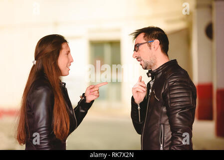 Angry millennial couple arguing and blaming each other of problem, frustrated about their relationship. Stock Photo