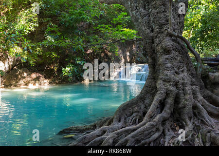 Jangle landscape with flowing turquoise water of Erawan cascade waterfall at deep tropical rain forest. Park Kanchanaburi, Thailand Stock Photo