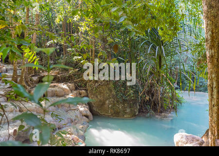 Jangle landscape with flowing turquoise water of Erawan cascade waterfall at deep tropical rain forest. Park Kanchanaburi, Thailand Stock Photo