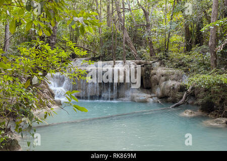 Jangle landscape with flowing turquoise water of Erawan cascade waterfall at deep tropical rain forest. Park Kanchanaburi, Thailand Stock Photo