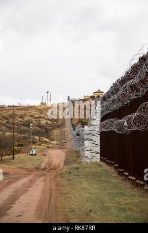 Nogales, Arizona - The U.S.-Mexico border fence, lighted up at night by ...