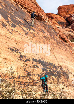 People climbing the rocks in Red Rock Canyon National Conservation Area, USA Stock Photo