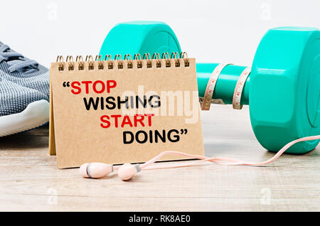 Stop wishing. Start doing. Fitness workout gym motivation quote. Stock Photo