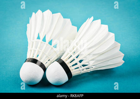 Badminton shuttlecocks on blue court floor. Stock Photo