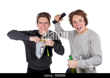 Two happy guys drinking beer and eating chips while watching football game Stock Photo