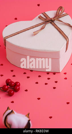 St. Valentine day background. Gift box with gold ribbon and lights on a pink background. Holiday background. Stock Photo
