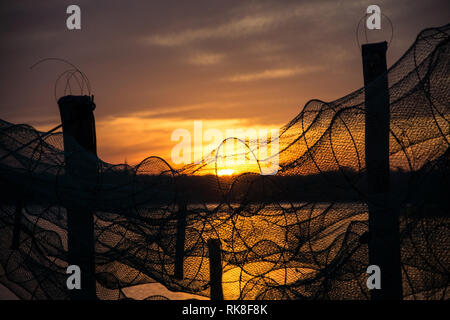 A fish trap is a stationary trap used for fishing. Stock Photo