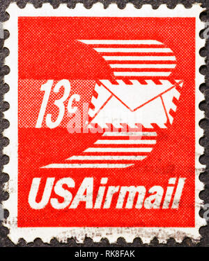 Envelope with wings on merican postage stamp Stock Photo