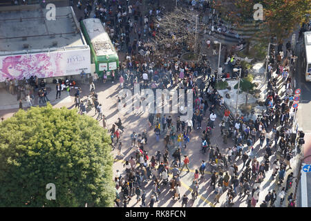 Elevated view of a crowed of pedestrians crossing a four way zebra crossing in central Tokyo, Japan Stock Photo