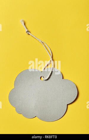 Designer label in the shape of a cloud without an inscription on a yellow background. space for text Stock Photo