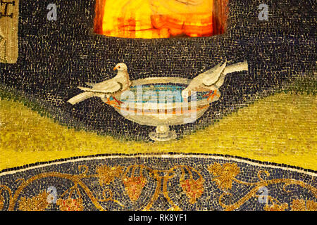 Two doves drinking in ancient mosaic of Ravenna, Italy. Detail from Byzantine Mausoleum of Galla Placidia. Stock Photo