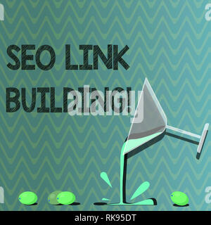 Text sign showing Seo Link Building. Conceptual photo getting other websites to link back your website Cocktail Wine Glass Pouring Liquid with Splash  Stock Photo