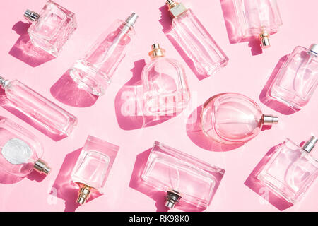 Perfume bottles on pink background Stock Photo