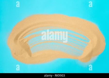 Sand heap on blue background Stock Photo