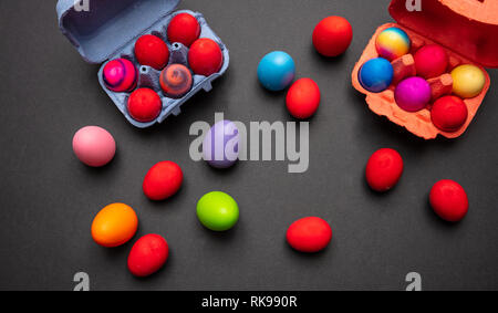 Happy easter. Easter eggs, pastel colors painted and a carton case, dark gray background Stock Photo