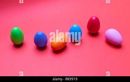 Easter eggs, pastel colors painted against orange color background Stock Photo