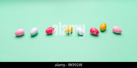 Easter eggs, pastel colors painted and decorated on green background, banner Stock Photo