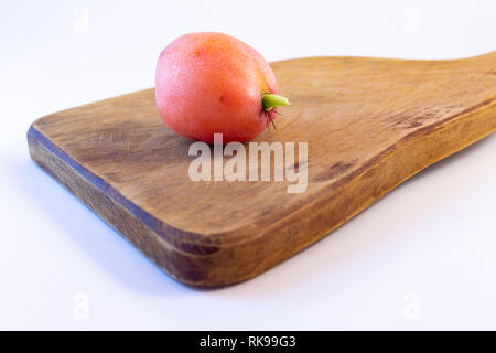 Exotic fruit of cactus on a wooden board. Sweet and soft tuna on white background. Stock Photo