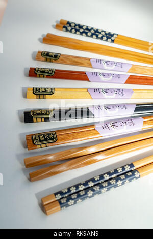 a selection of colourful chopsticks laid out on display Stock Photo