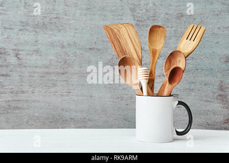 Kitchen utensils in ceramic cup on gray background, copy space Stock Photo