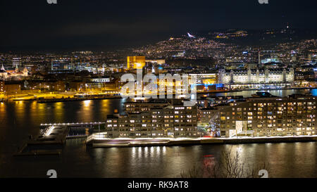 Oslo harbour with new family homes at night. The photo was taken from the Ekeberg hill. Stock Photo