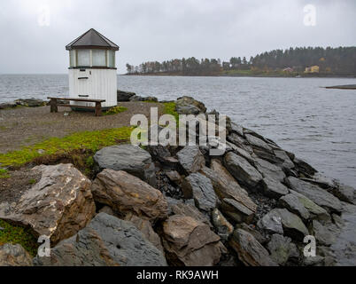 Small white wooden lighthouse in Vollen, Norway Stock Photo
