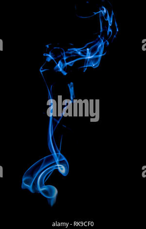 Abstract blue smoke swirls over black background Stock Photo - Alamy