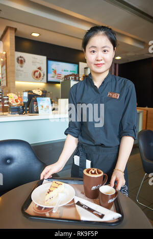 SHENZHEN, CHINA - MAY 06, 2016: Staff members of McCafe. McCafe is a coffee house style food and drink chain, owned by McDonald's. Stock Photo