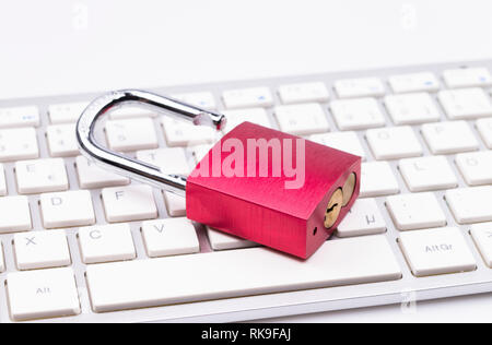 Red padlock on keyboard isolated on white background Stock Photo