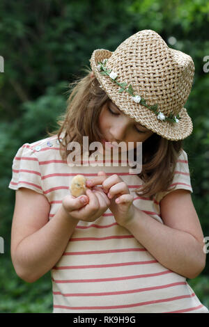 little girl is holding a young yellow chicken Stock Photo