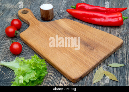 Oak cutting board on the kitchen table. Stock Photo