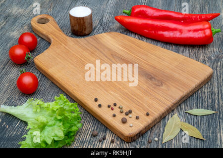 Oak cutting board on the kitchen table. Stock Photo
