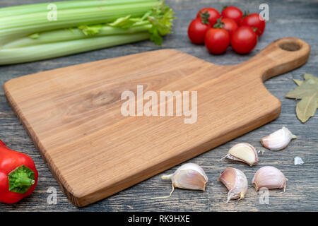 Oak cutting board on the kitchen table. Stock Photo