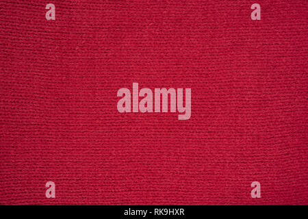 Texture of red knitted fabric. Stock Photo