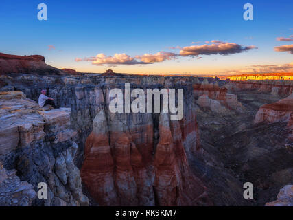 Tourist enjoys the sunset at the Coal Mine Canyon in Arizona Stock Photo