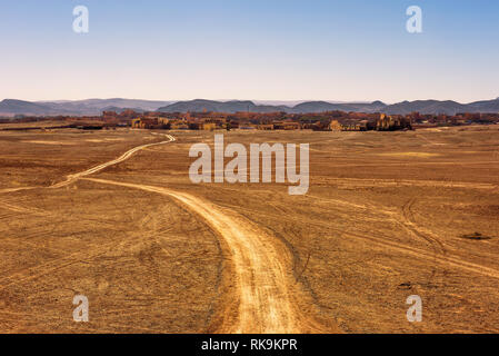 Dirt road going to the city of Ouarzazate in Morocco Stock Photo