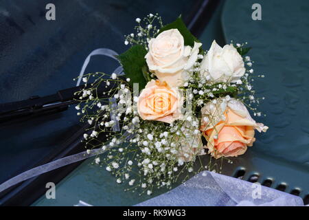 Roses, bunch of flowers tied to a car rear view mirror, Germany, Europe
