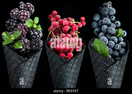 Ice cream cones filled with frozen berry fruits. Stock Photo