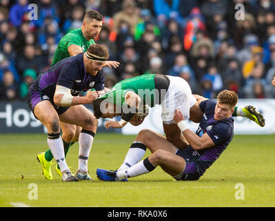 Edinburgh, Scotland, UK. 9th Feb 2019. Ireland's New Zealand born Centre, Bundee Aki, is stopped in his tracks during the first half as Scotland play host to Ireland in their second game of the 2019 6 Nations Championship at Murrayfield Stadium   in Edinburgh.  (Photo by Ian Jacobs) Credit: Ian Jacobs/Alamy Live News