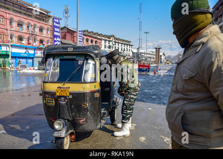 Srinagar, India. 9th Feb 2019. An Indian army man seen checking a vehicle during restrictions in Srinagar. Restriction on the movement of vehicles were imposed protectively in parts of Srinagar as separatist groups called for a strike on the anniversary of execution of Afzal Guru, a Kashmiri who was convicted and given a death sentence for his role in the 2001 attack on Indian Parliament. Credit: SOPA Images Limited/Alamy Live News Stock Photo