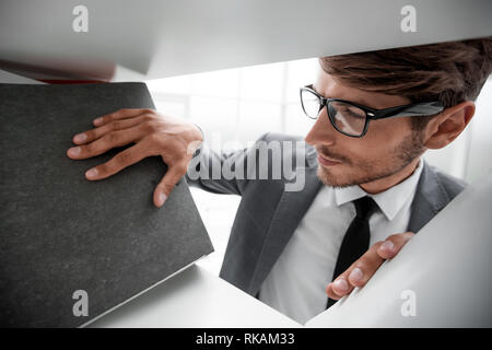 Close-up of human hands holding a stack of folders with business documents on the foreground Stock Photo