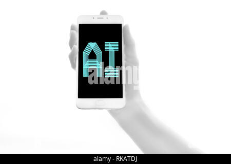 Human bionic hands holding electronic device on white background. Humanoid robot hands close-up. Artificial intelligence futuristic concept Stock Photo