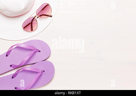 Beach accessories on a white background - sunglasses, slippers and hat. summer comes concept Stock Photo