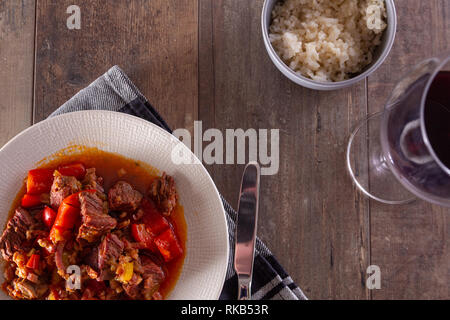 A plate with goulash or beef stew on the table. Photographed in a flat top down view. Stock Photo