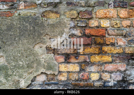 Old rustic brick wall with bits of grey plaster - high quality texture / background Stock Photo