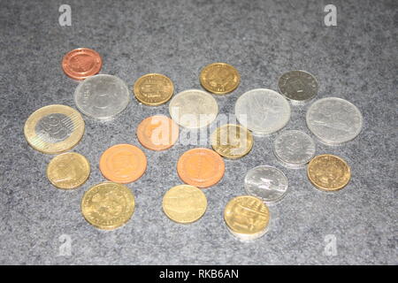 golden and silver coins with sunlight on wooden background Stock Photo