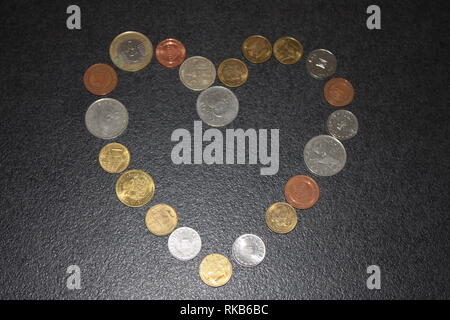 golden and silver coins with sunlight on wooden background Stock Photo