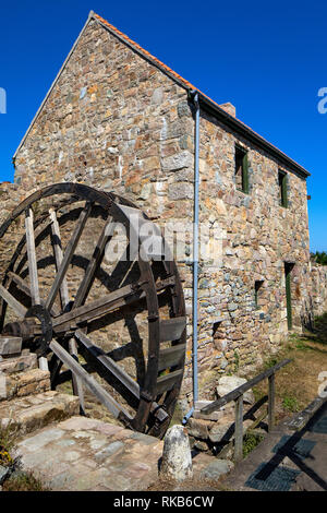 The old watermill and water wheel recently rebuilt near watermill farm on Alderney. Stock Photo